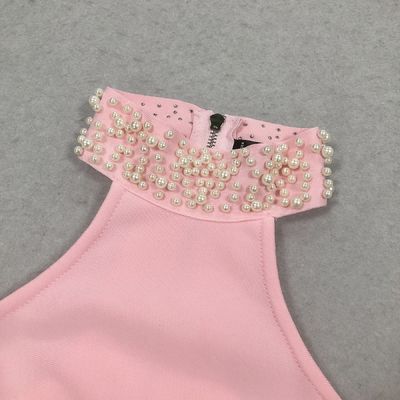 Unleash Your Inner Fashionista with this Pink Bandage Two-Piece Set featuring Pearl Details and High Slit Skirt